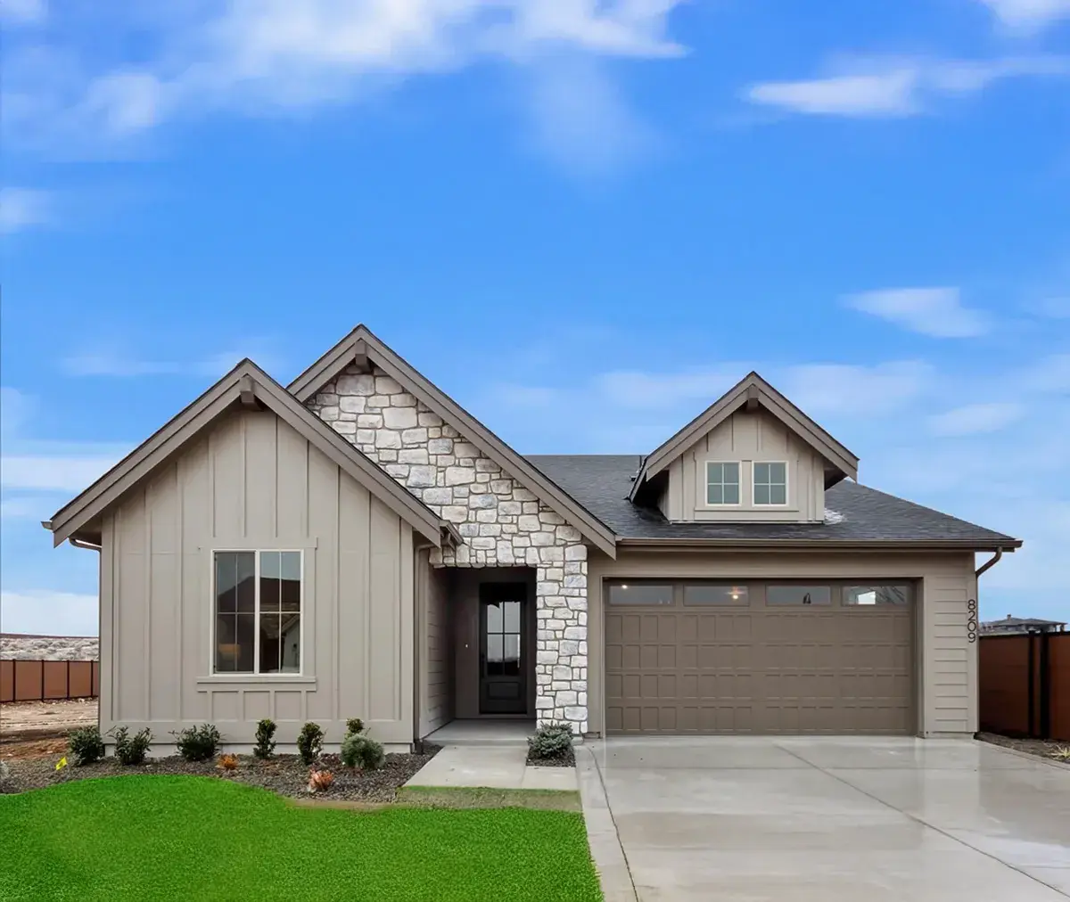 Grey exterior with stone facade on this new construction home Berkeley Building Co. Homes by Clayton.