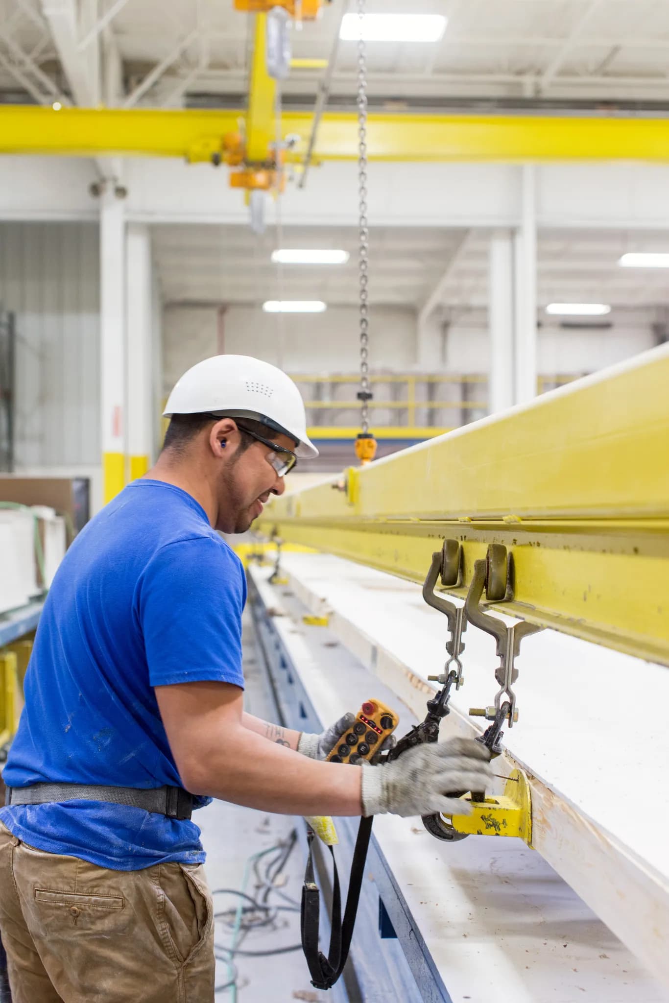 Man works inside a Clayton Homes climate controlled modern manufactured building facility.