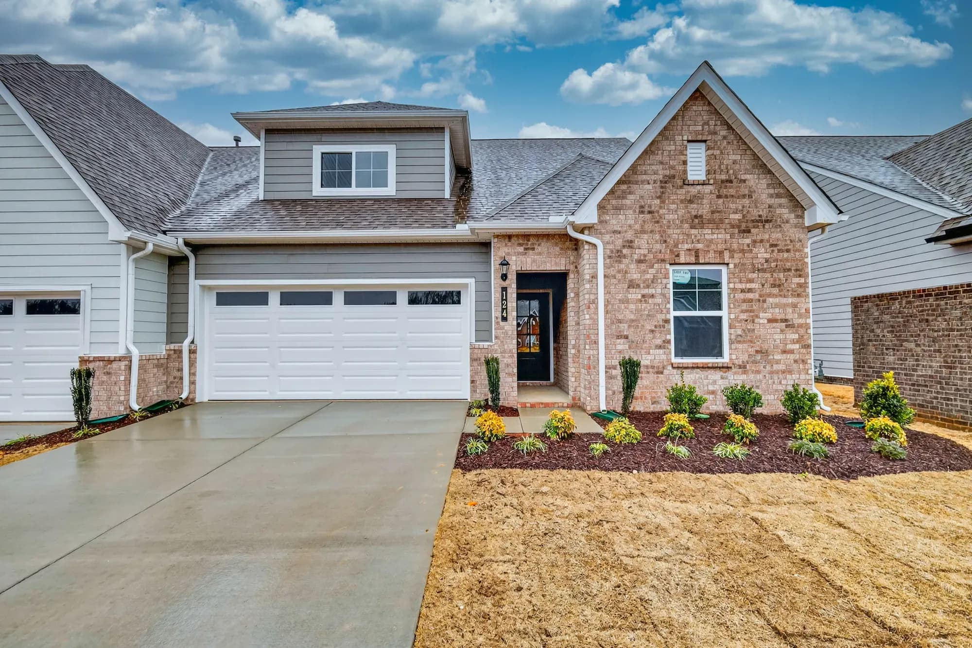 Two-story brick exterior new construction site-built home by Goodall Homes, a Clayton company.