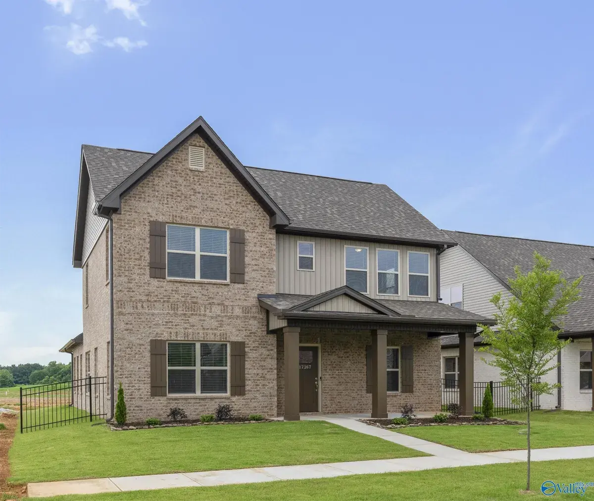 Two-story brick exterior new construction site-built home by Legacy Homes, a Clayton company.