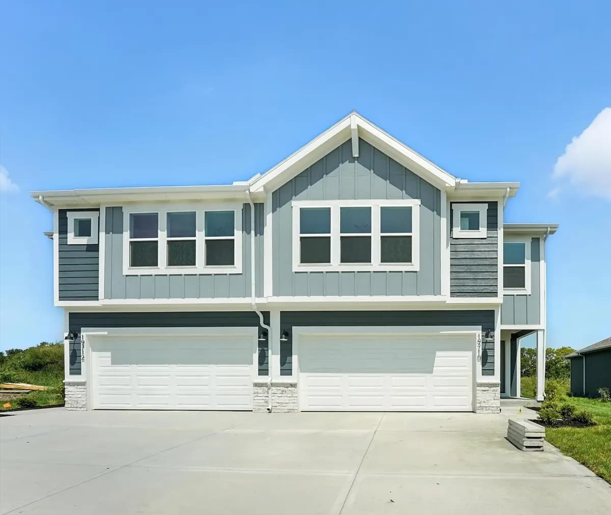 Blue and white exterior new construction two-story homes built by Summit Homes, a Clayton company.
